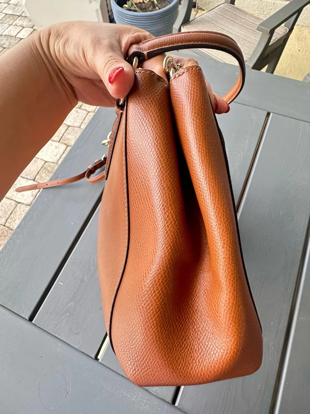 Coach Christie Carryall in a brown, textured leather with gold-tone hardware